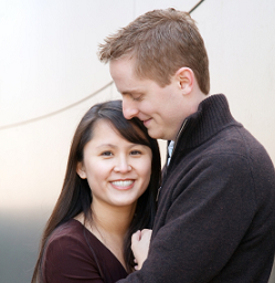 Young interracial couple, smiling fondly at each other; you can see that they are very much in love