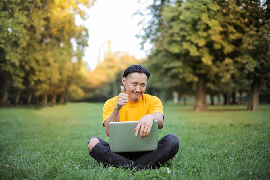 Indigenous man gives thumbs up after online therapy session by video conferencing