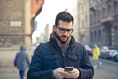 Man with smart phone doing psychotherapy online by video conferencing