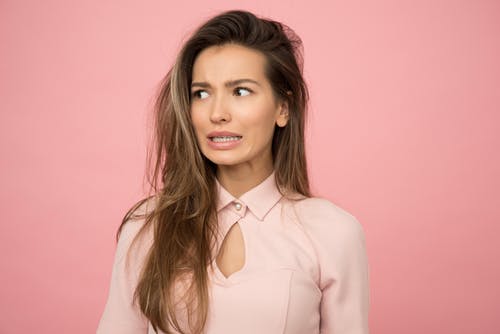 Woman looks wary as she wonders about the possible risks in online therapy